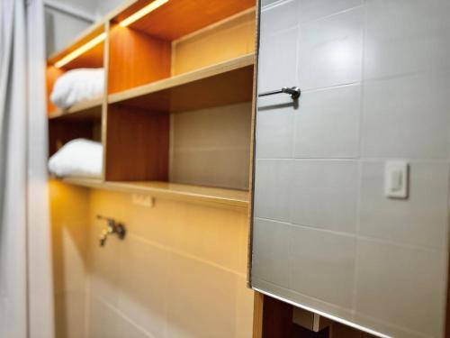 a bathroom with a mirror and a closet at Bears Nook - Marina Spatial Dumaguete in Piapi