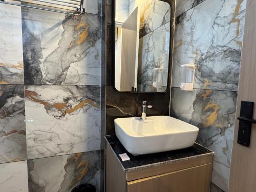 a bathroom with a sink and a mirror at Hotel The Merc in Kharar