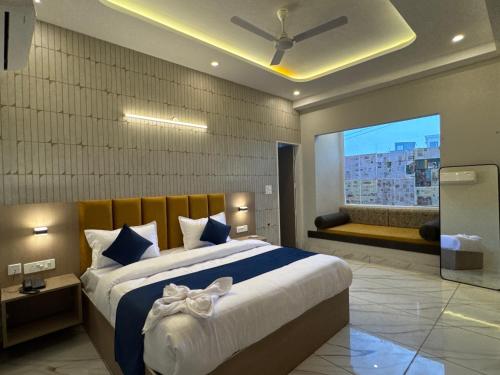 a bedroom with a large bed and a window at Hotel The Merc in Kharar
