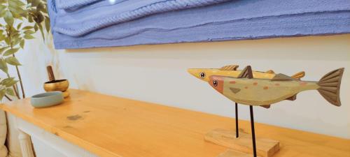 a wooden fish statue sitting on top of a wooden table at Casa Playa Moncofa in Moncófar