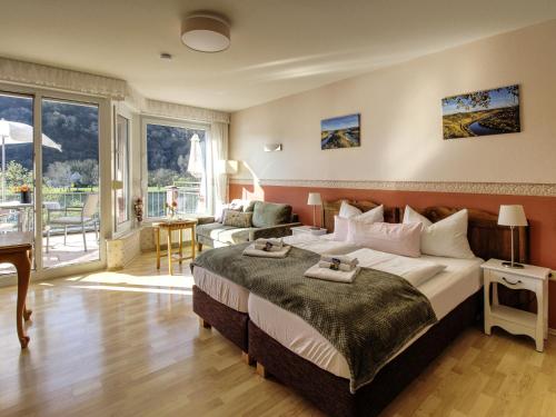 a bedroom with a large bed and a living room at Ferienhaus Bullay in Bullay
