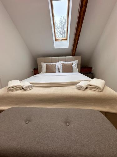 a bedroom with a large bed with two pillows at Norderney Apartments in Sibiu
