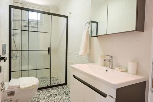 a bathroom with a toilet and a sink and a shower at Villa Egeden 2 in Fethiye