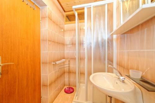 a bathroom with a sink and a shower at Rooms Milica in Palit
