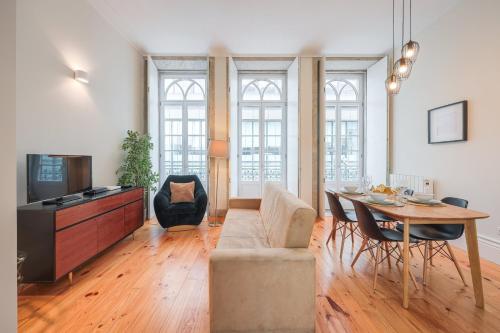 a living room with a couch and a table at Aliados Town Hall Central Apt by LuxiStay in Porto