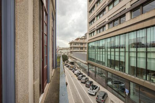 arial view of cars parked in a parking lot in a city at Aliados Town Hall Central Apt by LuxiStay in Porto