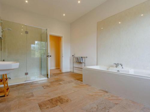 a bathroom with a tub and a sink and a shower at 7 Bed in Dollar oc-88668 in Powmill