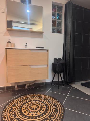 a bathroom with a sink and a bathroom rug at Eaunes au Soleil in Eaunes