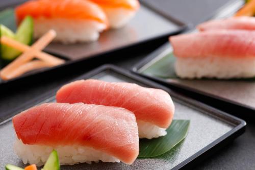 a plate of sushi with salmon and rice at HOTEL MYSTAYS Fuji Onsen Resort in Fujiyoshida