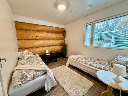 a bedroom with two beds and a window at Villa Cuisine in Joensuu