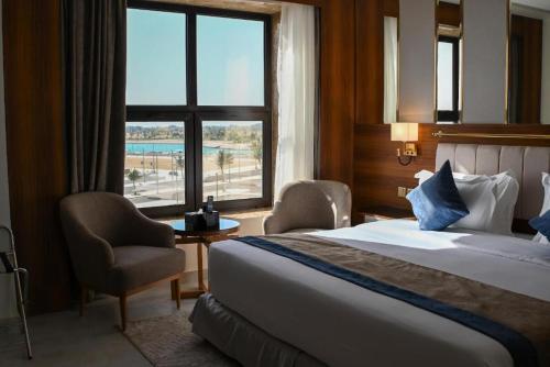 a hotel room with a large bed and a window at Corp Yanbu Hotel - B2 in Yanbu