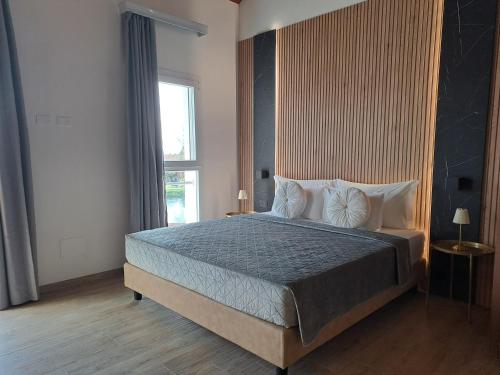 a bedroom with a large bed and a window at Antica Jesolo - M Factory in Jesolo