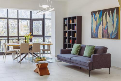 a living room with a couch and a table at Spacious 3BR Retreat Overlooking Marina in Msida