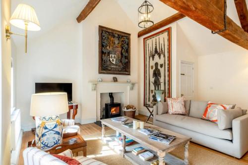 a living room with a couch and a table at The Coach House in Barlestone