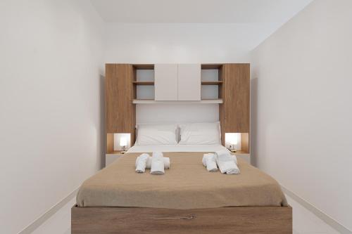 a bedroom with a bed with towels on it at Marusu Apartments By Dimora Hub in Terrasini