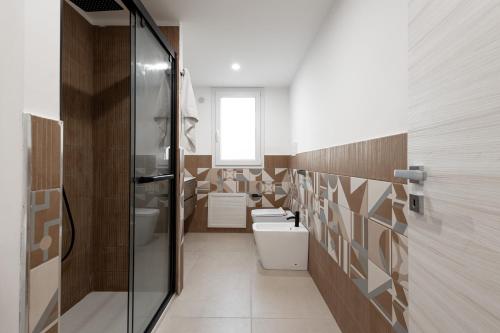 a bathroom with two toilets and a glass shower at Marusu Apartments By Dimora Hub in Terrasini