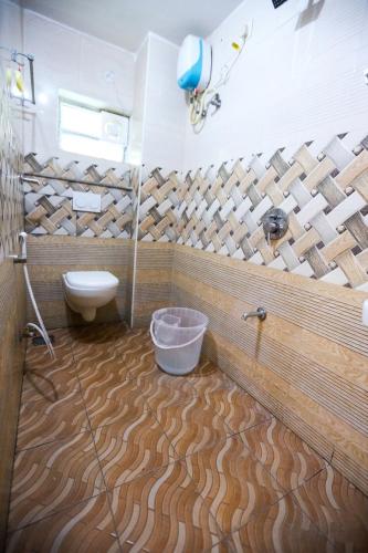 a bathroom with a toilet and a sink at Starlight Hotels DLF Trade Center Miot chennai in Chennai