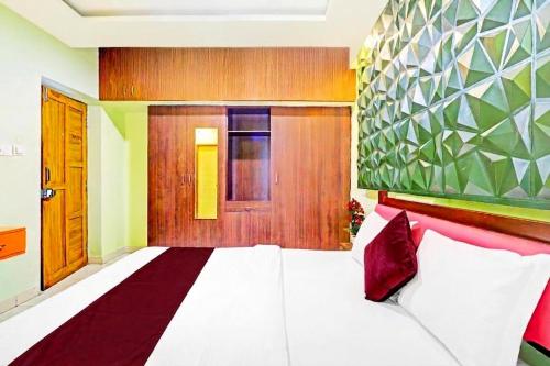 a bedroom with a large white bed and a door at Starlight Hotels DLF Trade Center Miot chennai in Chennai