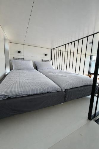 a large bed in a room with a window at EMSLAND-CAMP in Haar