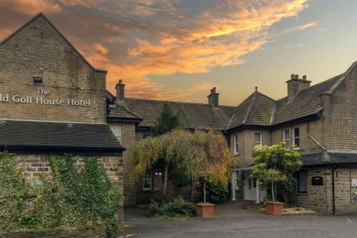 a row of houses with a sign for the golf house hotel at The Old Golf House Sure Hotel Collection by Best Western in Huddersfield