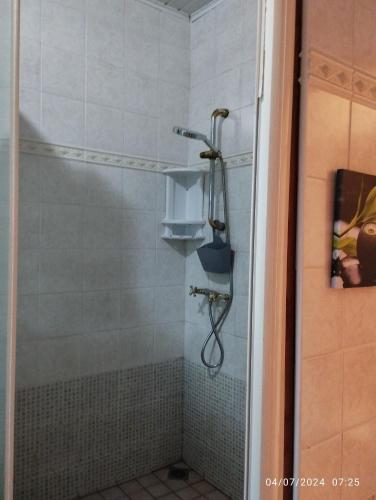 a shower with a shower head in a bathroom at Appartement 974 in Le Tampon