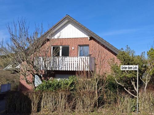 a brick house with a sign in front of it at Ferienwohnung Hoher Pön in Willingen