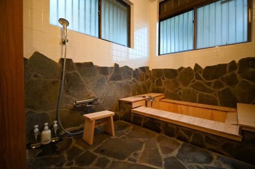 a bathroom with a shower and a tub and a sink at Beppu TOJIHAUS 002 Hilltop Sea View 8min walk to Hells of Beppu in Beppu