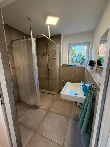 a bathroom with a shower and a sink at Smart-Stay Bielefeld in Bielefeld