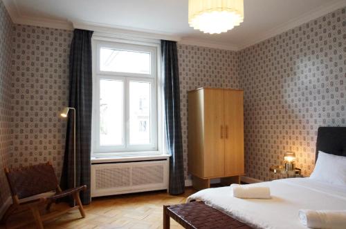 a bedroom with a bed and a window at ReLiving - Historic City Apartment in Lucerne
