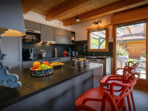a kitchen with a counter with a bowl of fruit on it at Chalet Sivara - OVO Network in Manigod