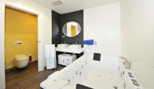 a bathroom with two sinks and a mirror at Hotel Salobreña Suites in Salobreña