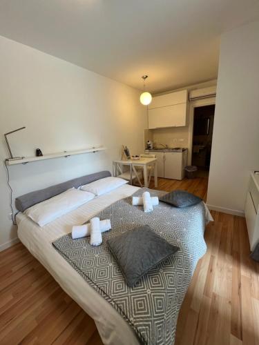 a bedroom with a large bed with towels on it at Apartments Annette - studio and two bedroom apartment with parking in Dubrovnik