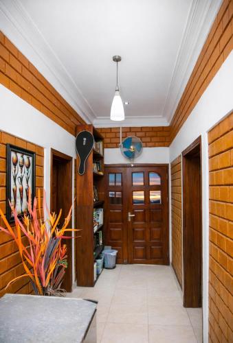 a hallway with wood paneling and wooden doors at Fern Haven in Port Harcourt