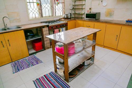 a kitchen with a counter in the middle of it at Fern Haven in Port Harcourt
