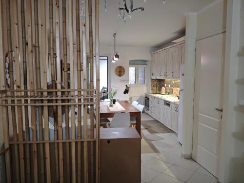 a kitchen with a table and a dining room at Villa Maxim in Corfu Town in Corfu
