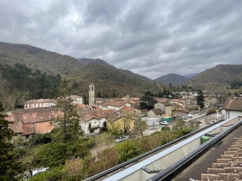 a view of a town with mountains in the background at LHE Terrazza Alba in Bagno di Romagna