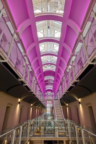 a large building with purple ceilings and a escalator at Malmaison Oxford in Oxford