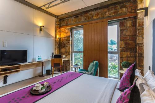 a bedroom with a large bed and a tv at Mana Ranakpur in Ranakpur
