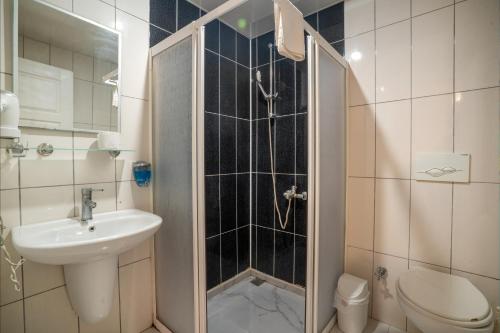 a bathroom with a shower and a sink and a toilet at Side Orientt Apartments in Side