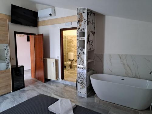 a bathroom with a white tub and a shower at Hotel-Ristorante KerMes in Boccaleone