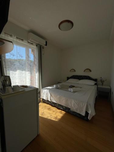 a bedroom with a bed and a large window at Villa Ivanovic in Budva