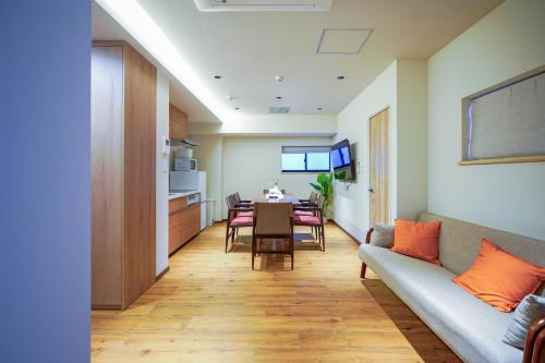 a living room with a couch and a table at Nakano World Hotel in Tokyo
