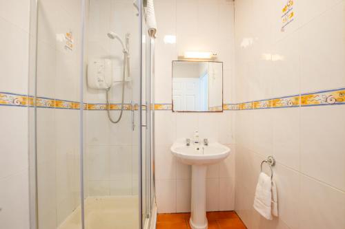 a white bathroom with a sink and a shower at Spacious 4-Bed Central Limerick Group Retreat in Limerick