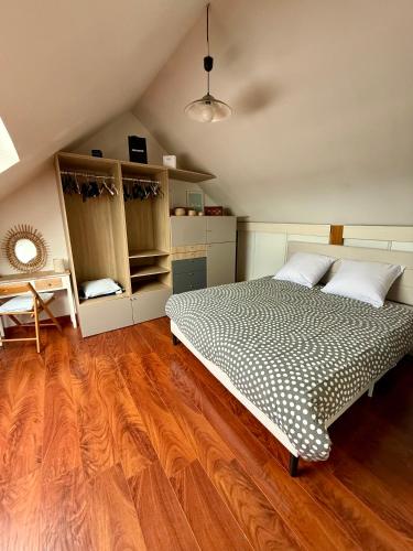 a bedroom with a bed and a wooden floor at Villa Bretagne 5 chambres doubles 3 SDB in Plérin