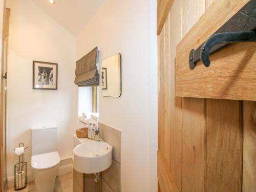 a small bathroom with a toilet and a sink at The Blacksmiths Shop in Bromyard