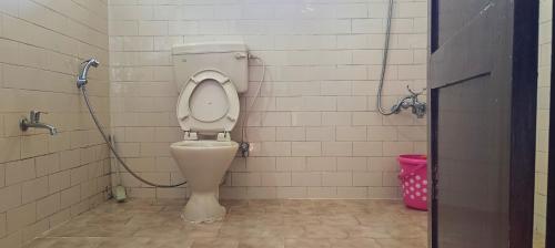 a bathroom with a toilet in a stall at Smiley Homestay Family-Friendly 3BR in Kodaikānāl