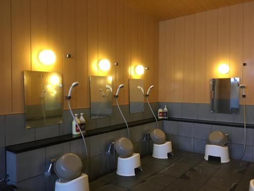 a group of three toilets in a public restroom at Hotel Crown Hills Kanazawa in Kanazawa