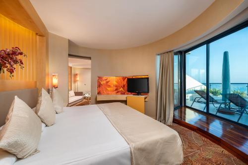a hotel room with a bed and a large window at Paloma Sencia in Belek