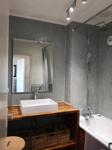 a bathroom with a sink and a tub and a mirror at Charming 96m2 fantastic view in Tourcoing