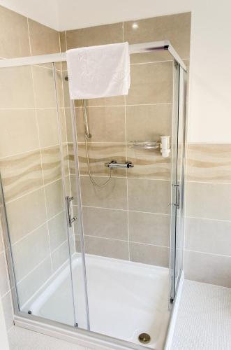 a shower with a glass door in a bathroom at The Avenue in Shanklin
